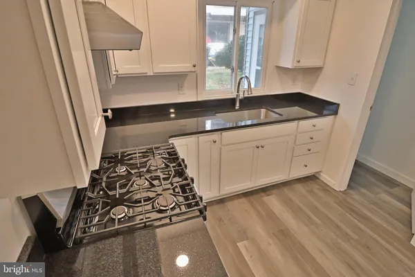 a kitchen with sink and cabinets