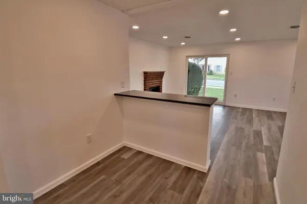 a view of a room with wooden floor and window