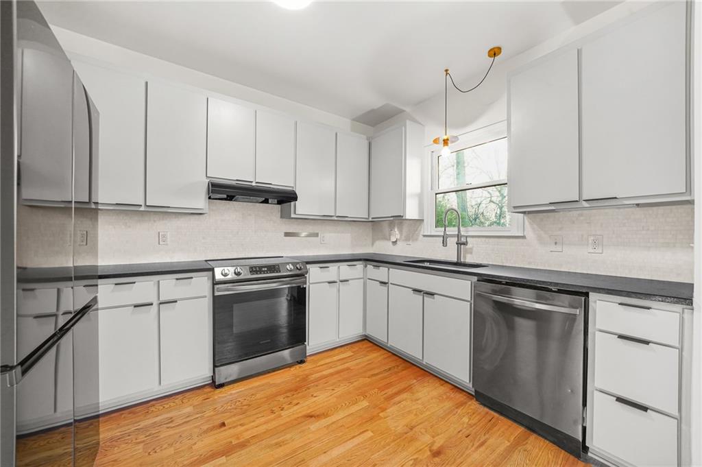 1086 Pine Grove Avenue Northeast Brookhaven, GA 30319 - Photo 11 of 33 a kitchen with stainless steel appliances granite countertop a sink stove and cabinets