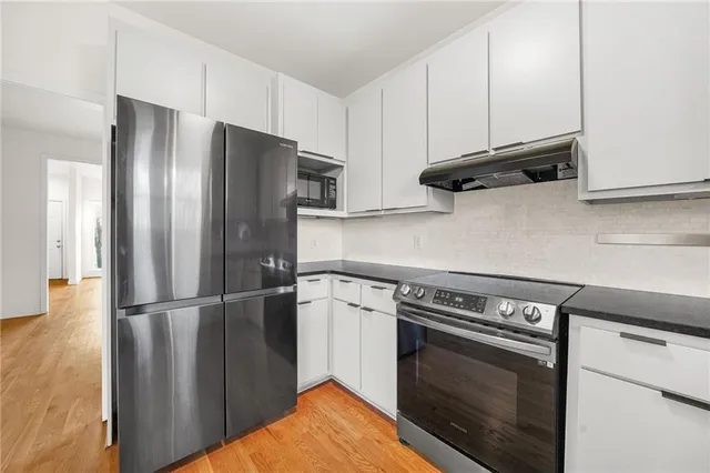 a kitchen with appliances and cabinets