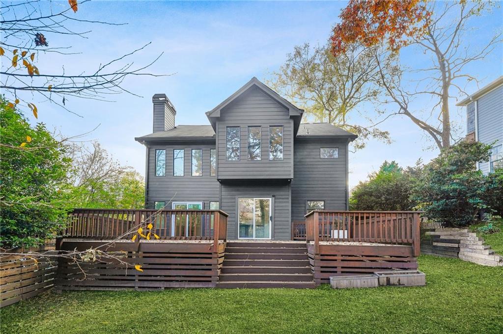 1086 Pine Grove Avenue Northeast Brookhaven, GA 30319 - Photo 29 of 33 a view of a house with wooden deck and a yard