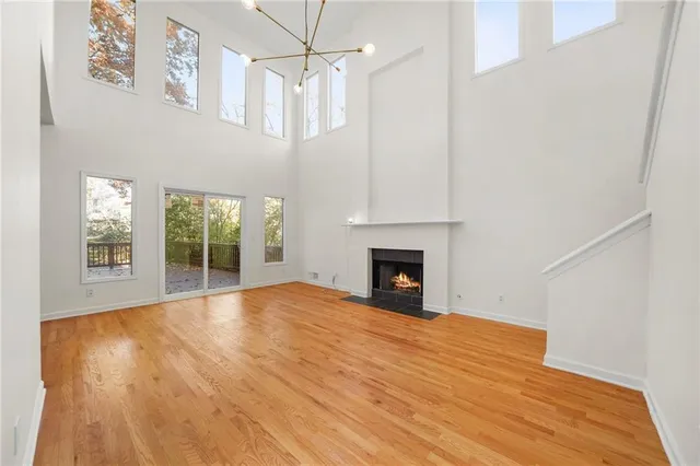a view of empty room with wooden floor and fireplace