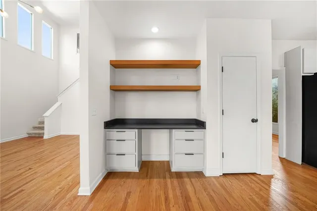 a kitchen with stainless steel appliances wooden floor and more cabinets