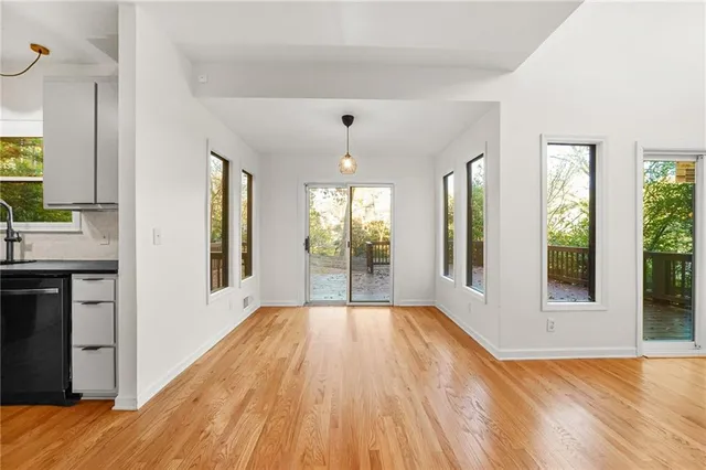a view of a room with wooden floor and outdoor space