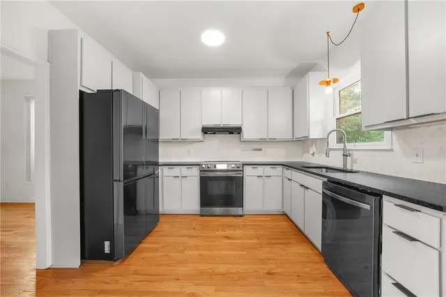 a kitchen with a refrigerator and a sink