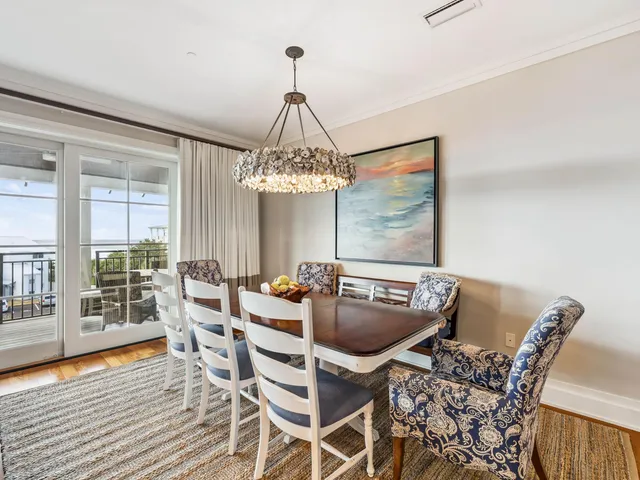 a view of a dining room with furniture wooden floor and chandelier