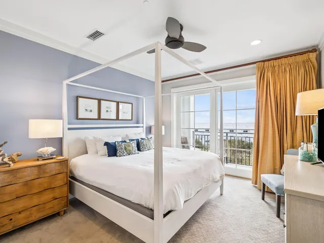 a bedroom with a bed and large window