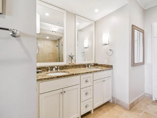 a bathroom with a granite countertop sink mirror and