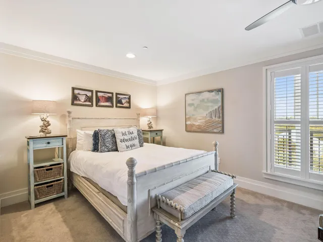 a bedroom with a bed and a dresser next to a window