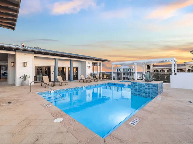 a view of a swimming pool with outdoor seating