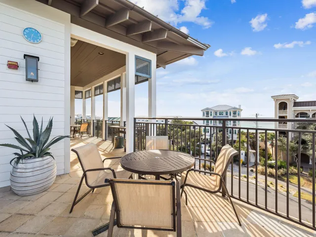 a view of a balcony with furniture and a potted plant
