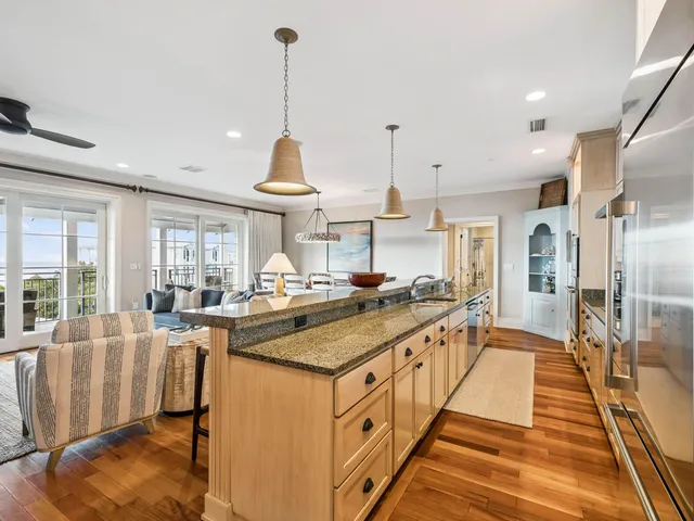 a large kitchen with kitchen island a large counter top space a sink and stainless steel appliances