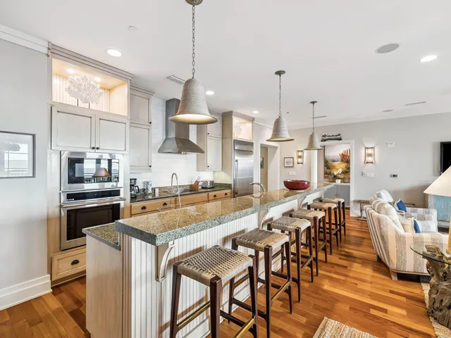 a large kitchen with a table and chairs