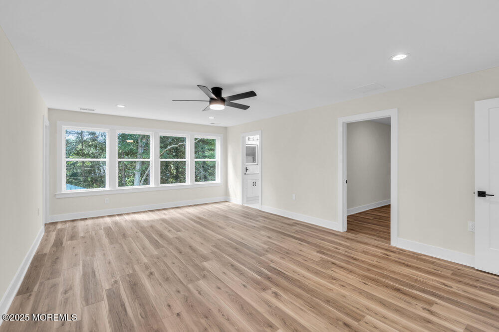 1730 Old Freehold Road Toms River, NJ 08755 - Photo 21 of 41 a view of an empty room with wooden floor and a window