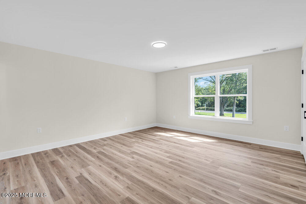 1730 Old Freehold Road Toms River, NJ 08755 - Photo 27 of 41 a view of an empty room with wooden floor and a window