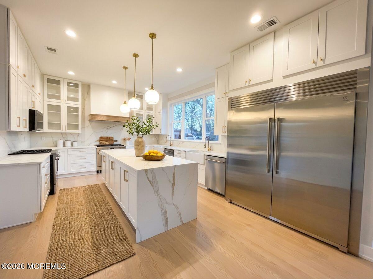 1730 Old Freehold Road Toms River, NJ 08755 - Photo 8 of 41 a kitchen with stainless steel appliances granite countertop a refrigerator a sink dishwasher a stove and white cabinets with wooden floor