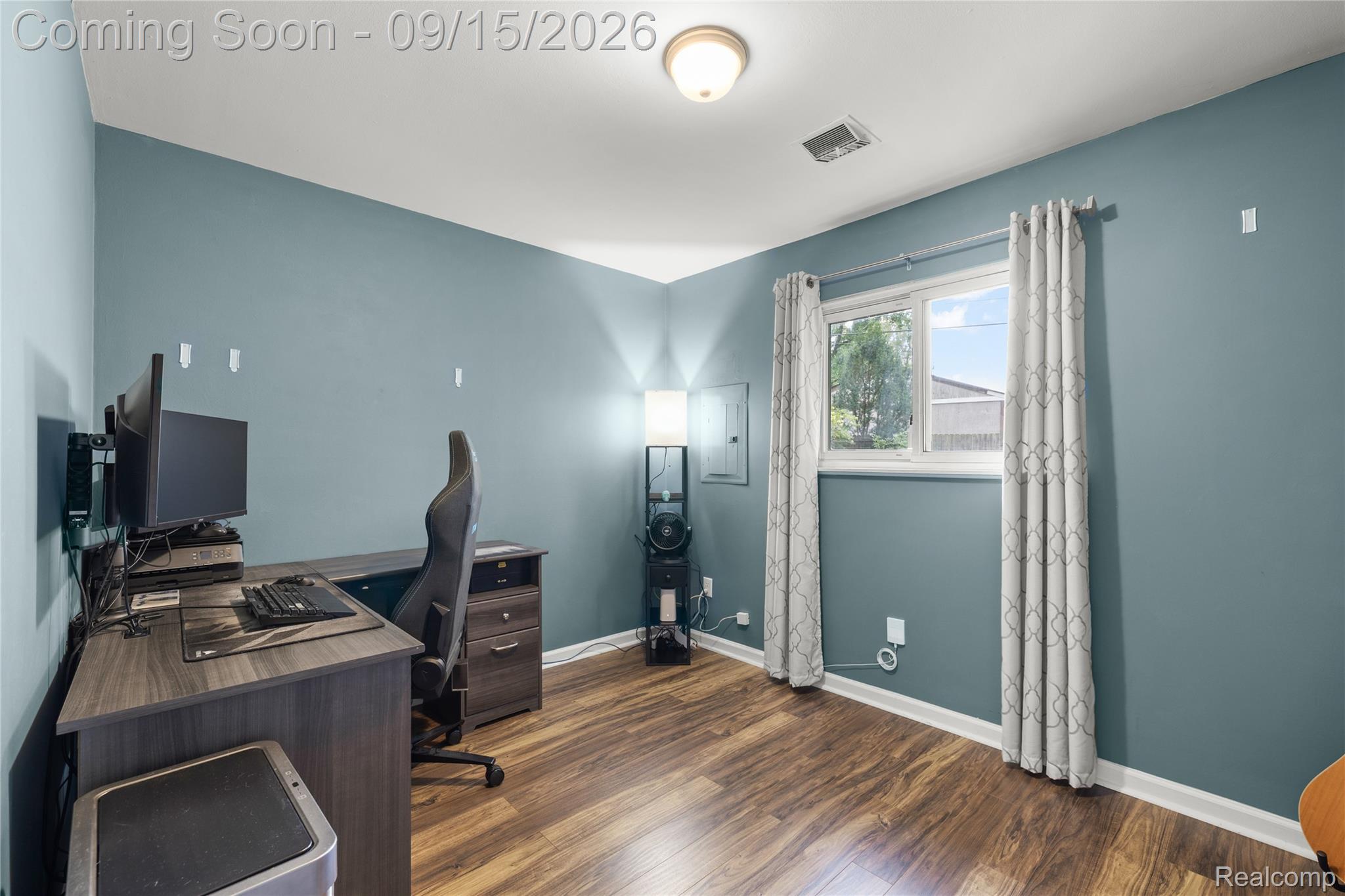 22947 Tuck Road Farmington, MI 48336 - Photo 19 of 34 Wood-finish flooring, light blue wall paint, and a window with natural light