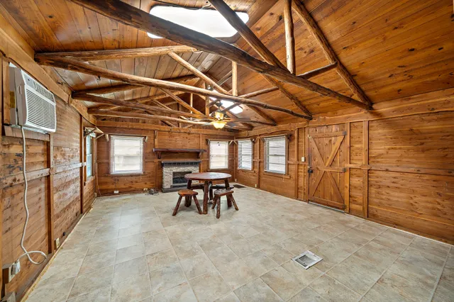 a view of a porch with furniture and a yard