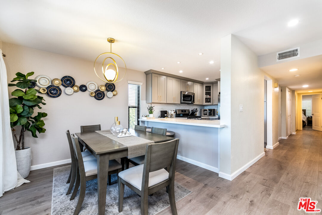 231 Bethany Road, Unit 210 Burbank, CA 91504 - Photo 1 of 22 a kitchen with a table and chairs in it