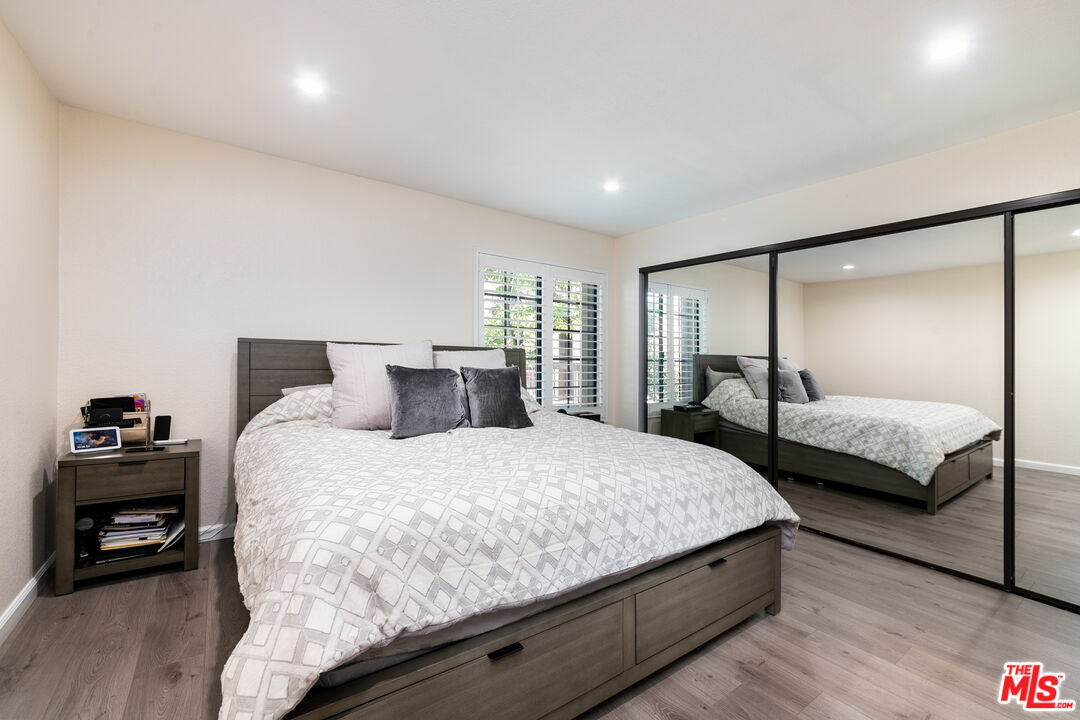 231 Bethany Road, Unit 210 Burbank, CA 91504 - Photo 14 of 22 a bedroom with a bed and a large window