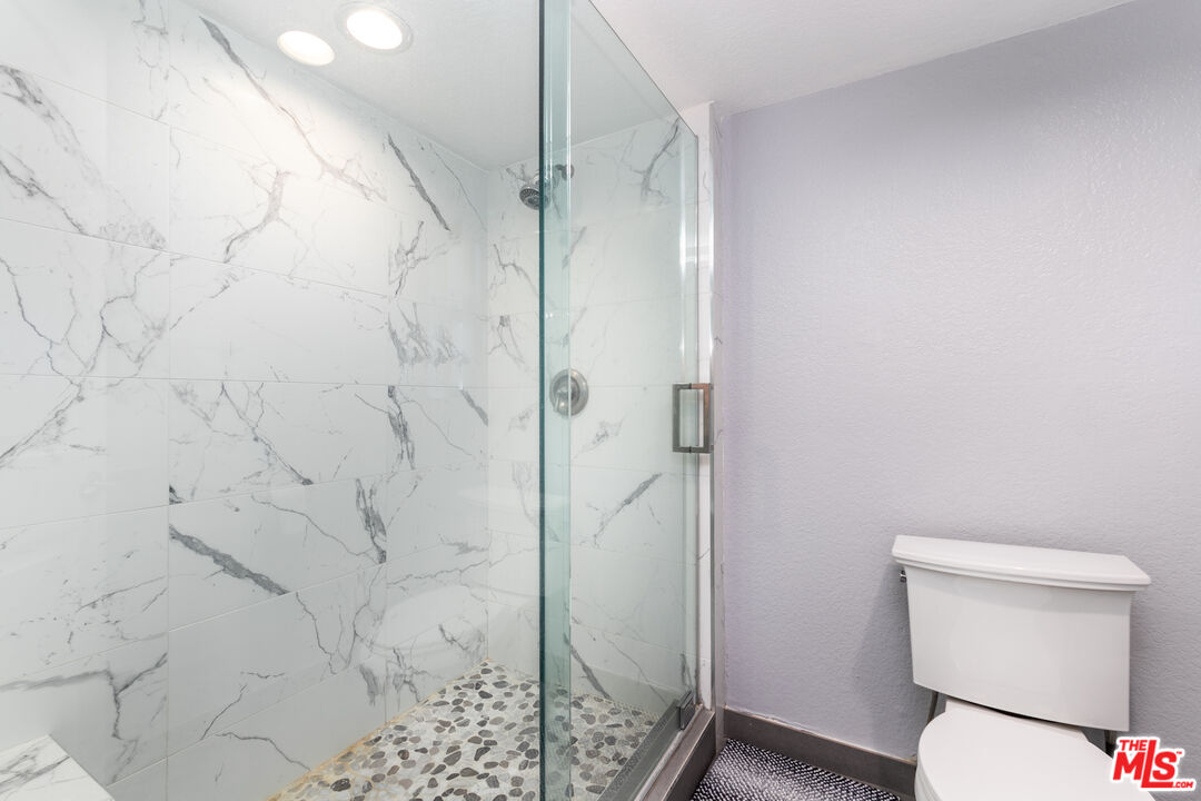 231 Bethany Road, Unit 210 Burbank, CA 91504 - Photo 16 of 22 a bathroom with a shower and toilet