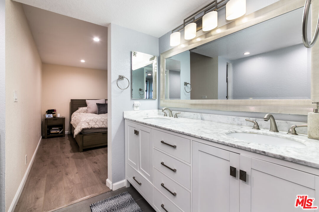 231 Bethany Road, Unit 210 Burbank, CA 91504 - Photo 17 of 22 a en suite bathroom with a granite countertop sink and mirror