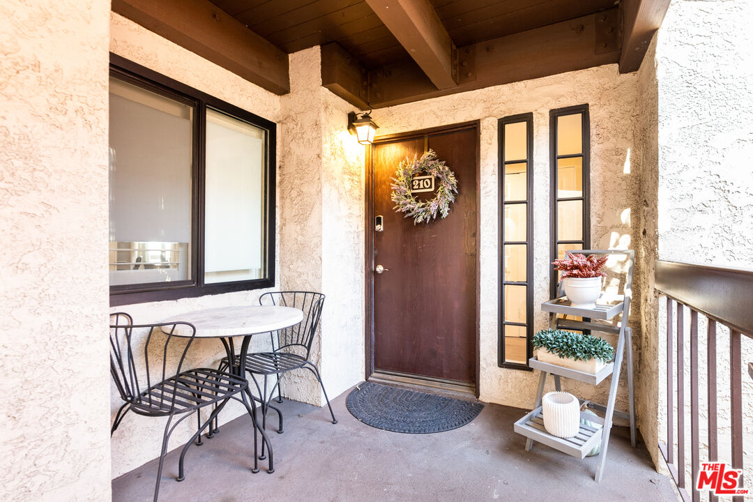 231 Bethany Road, Unit 210 Burbank, CA 91504 - Photo 20 of 22 a view of a hallway with furniture and front door