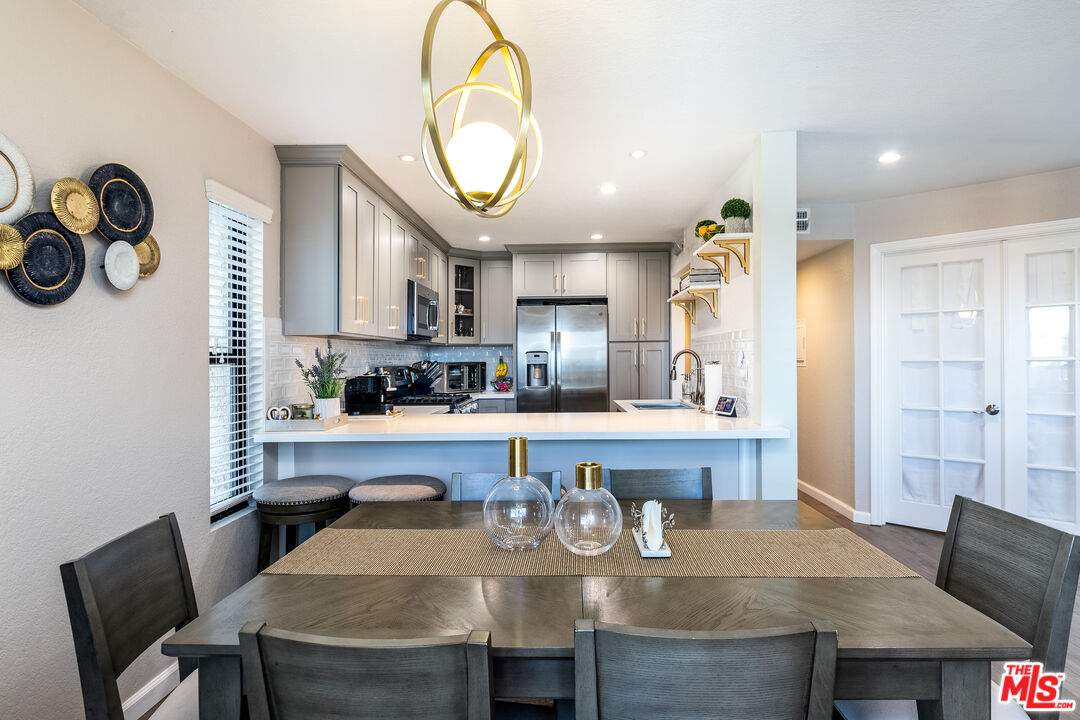 231 Bethany Road, Unit 210 Burbank, CA 91504 - Photo 2 of 22 a kitchen with a table and chairs in it