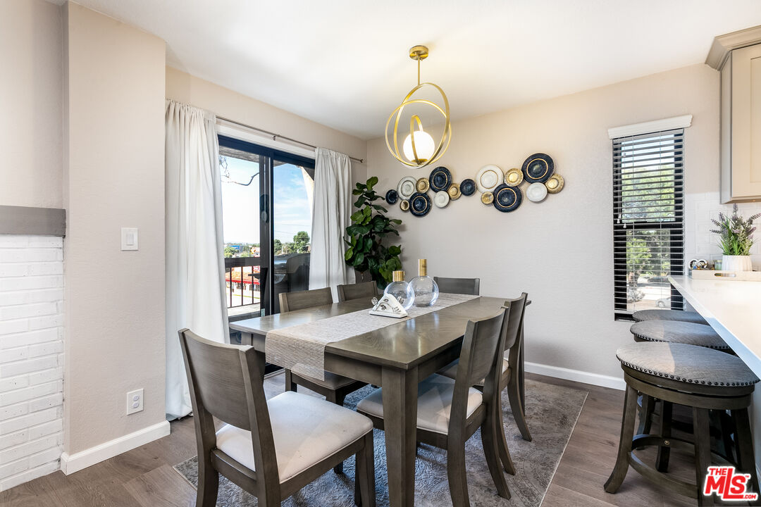 231 Bethany Road, Unit 210 Burbank, CA 91504 - Photo 6 of 22 a view of a dining room with furniture window and wooden floor