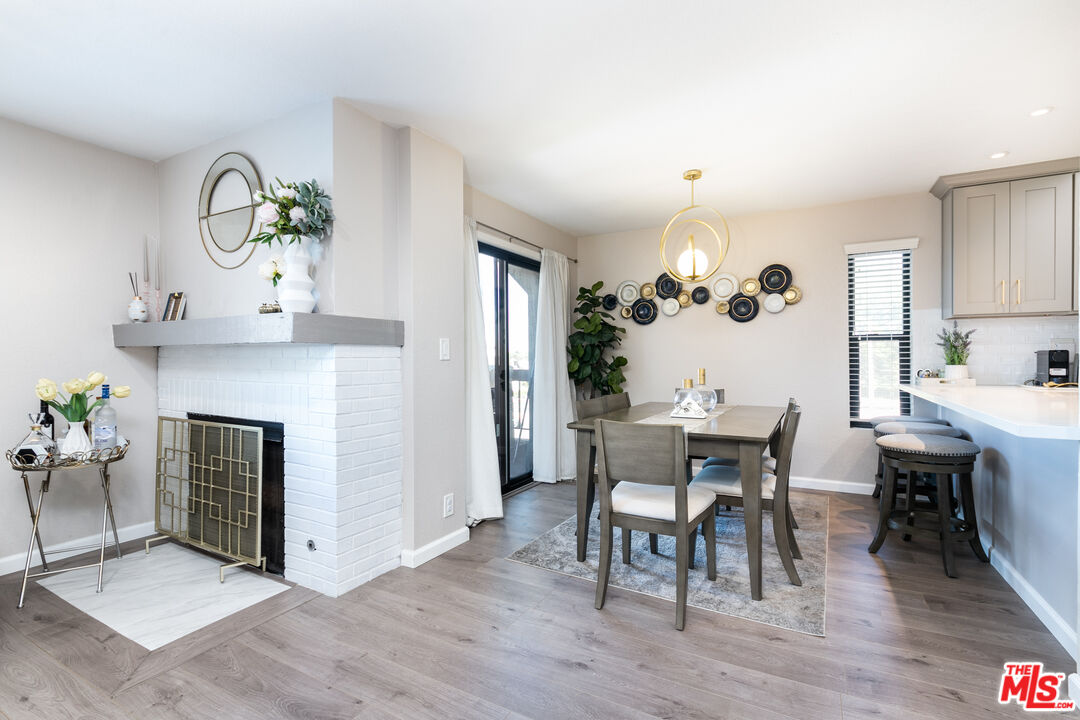 231 Bethany Road, Unit 210 Burbank, CA 91504 - Photo 7 of 22 a view of a dining room with furniture and wooden floor
