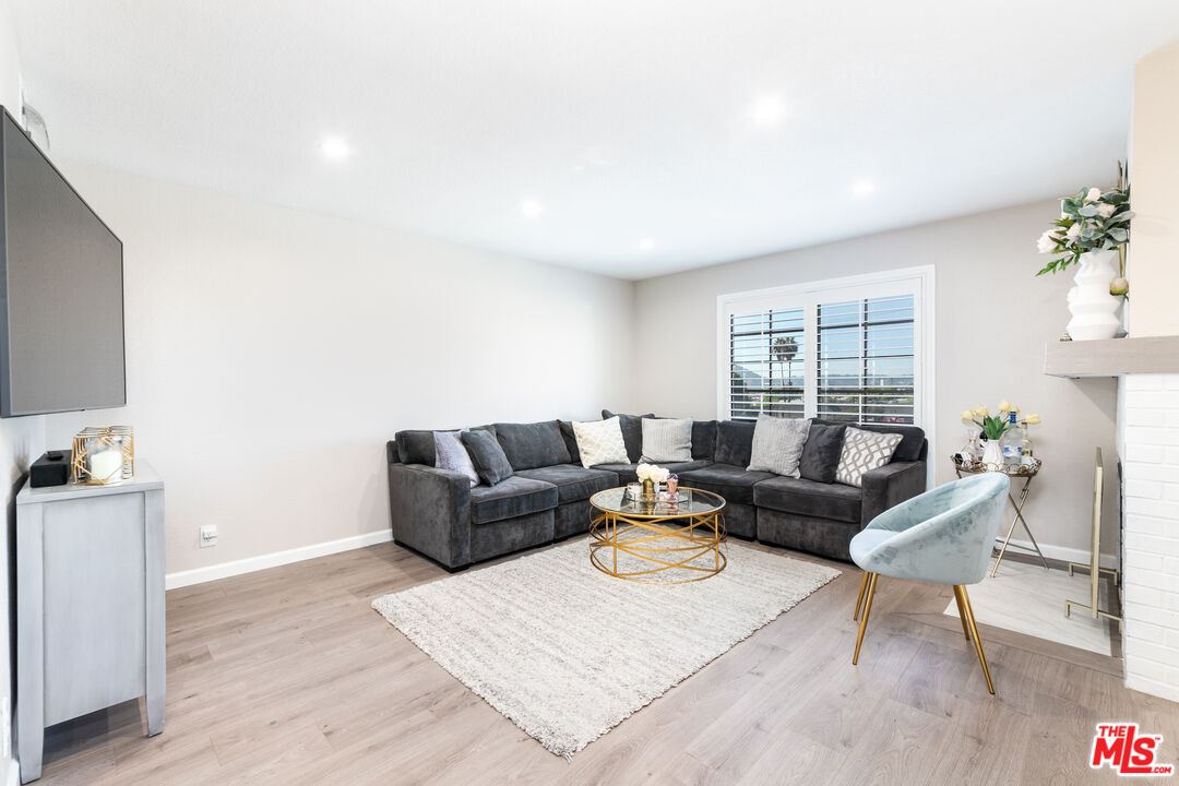 231 Bethany Road, Unit 210 Burbank, CA 91504 - Photo 8 of 22 a living room with furniture and a window