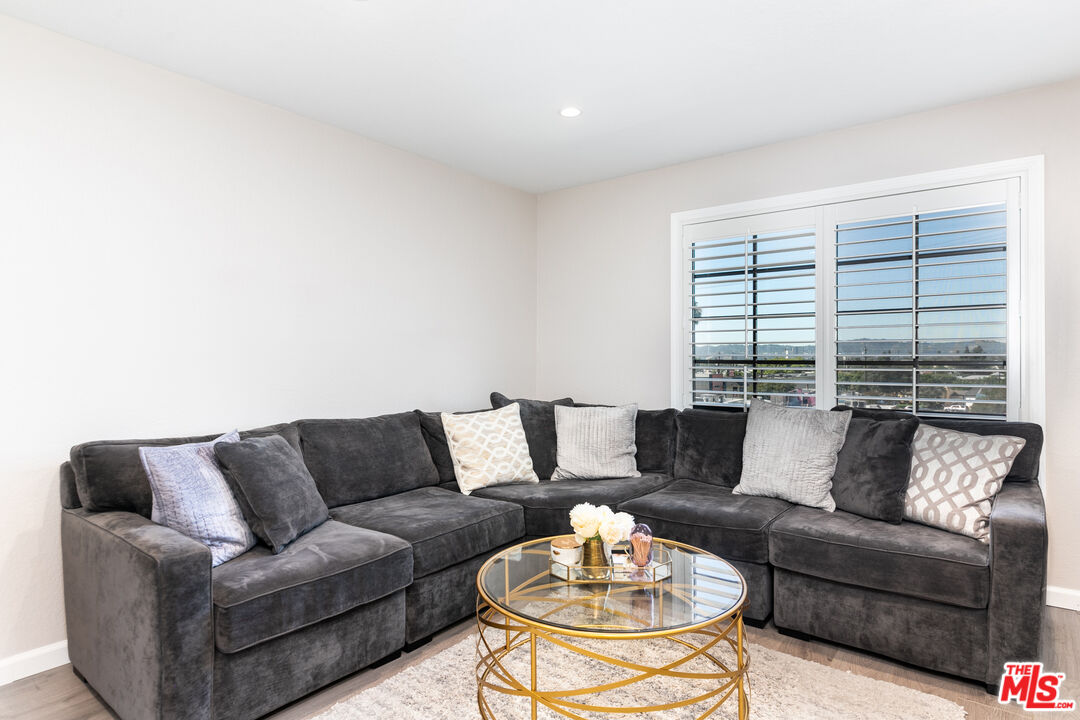 231 Bethany Road, Unit 210 Burbank, CA 91504 - Photo 9 of 22 a living room with furniture and a large window