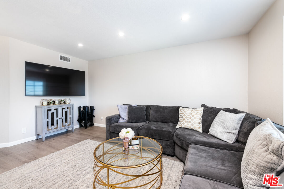 231 Bethany Road, Unit 210 Burbank, CA 91504 - Photo 10 of 22 a living room with furniture and a flat screen tv