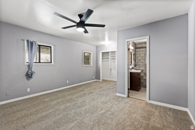 2576 Gramercy Avenue Ogden, UT 84401 - Photo 14 of 20 Unfurnished bedroom featuring a closet, light carpet, and a ceiling fan