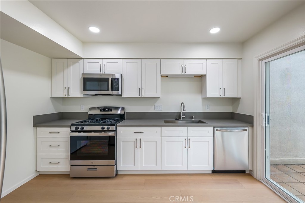 71 Seton Road Irvine, CA 92612 - Photo 6 of 22 a kitchen with stainless steel appliances granite countertop a stove and a sink