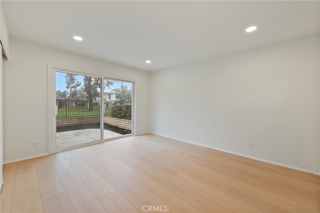 71 Seton Road Irvine, CA 92612 - Photo 8 of 22 a view of an empty room with wooden floor and a window
