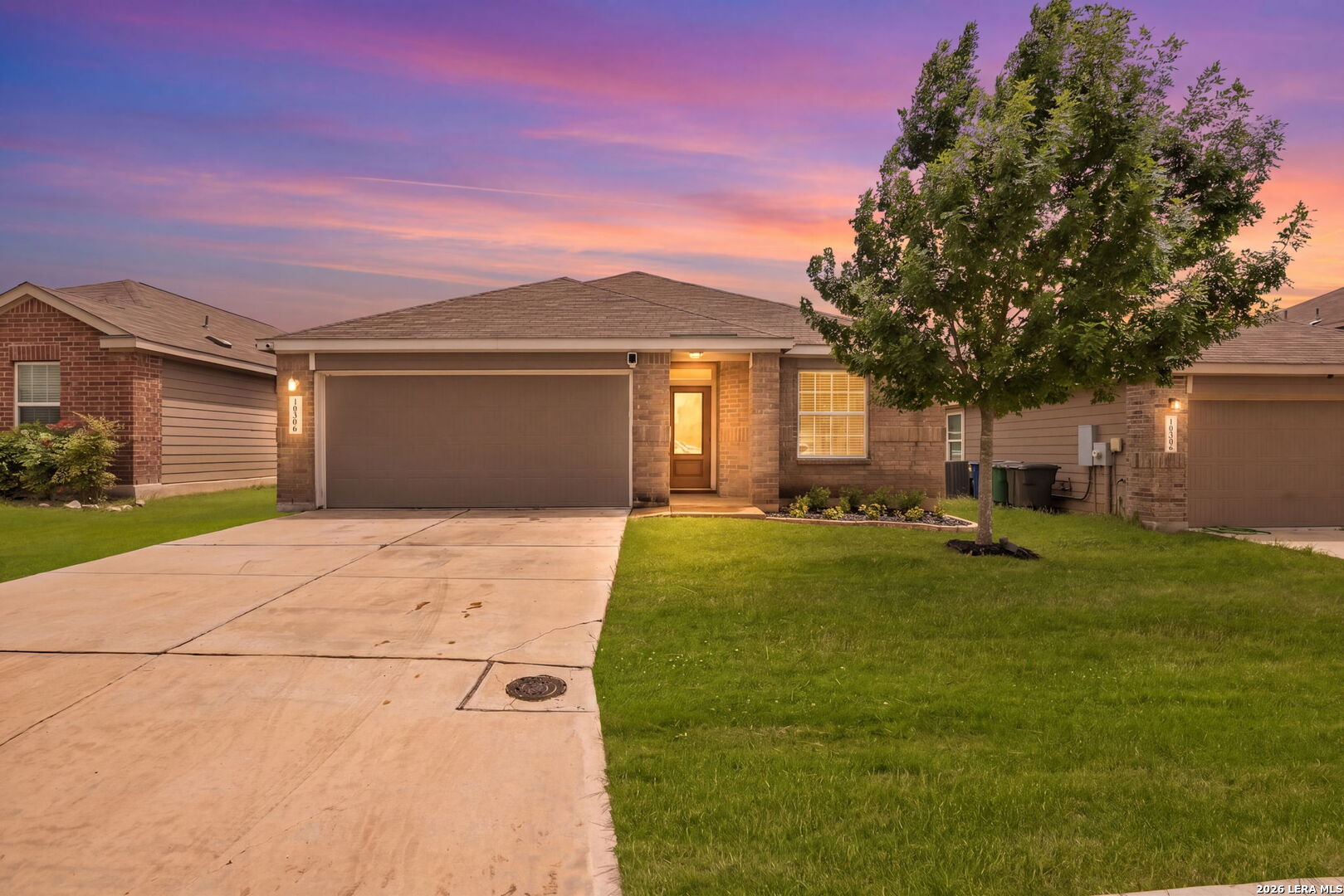 10306 Midsummer Meadow Converse, TX 78109 - Photo 1 of 26 a front view of a house with a yard and garage