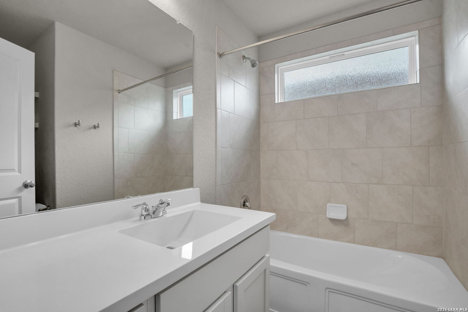 10306 Midsummer Meadow Converse, TX 78109 - Photo 16 of 26 a bathroom with a sink and a mirror