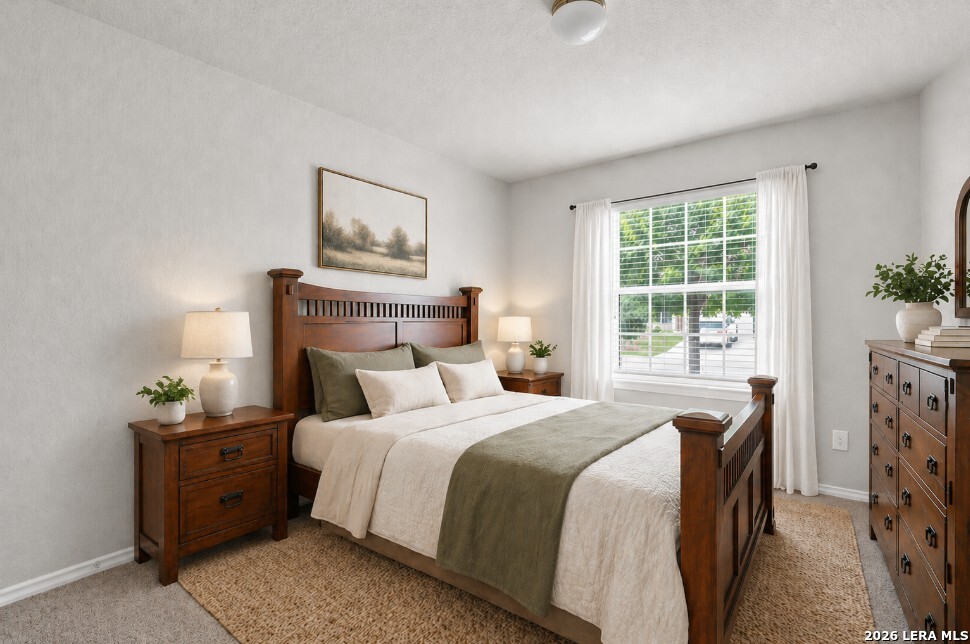 10306 Midsummer Meadow Converse, TX 78109 - Photo 17 of 26 a bedroom with a bed and a window