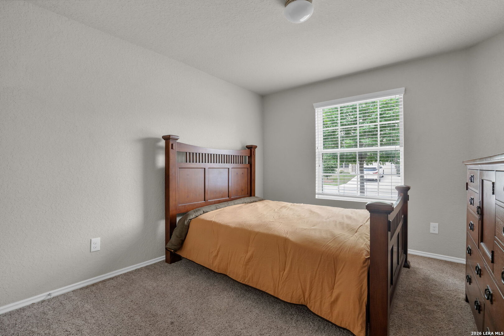 10306 Midsummer Meadow Converse, TX 78109 - Photo 18 of 26 a bedroom with a bed and a window