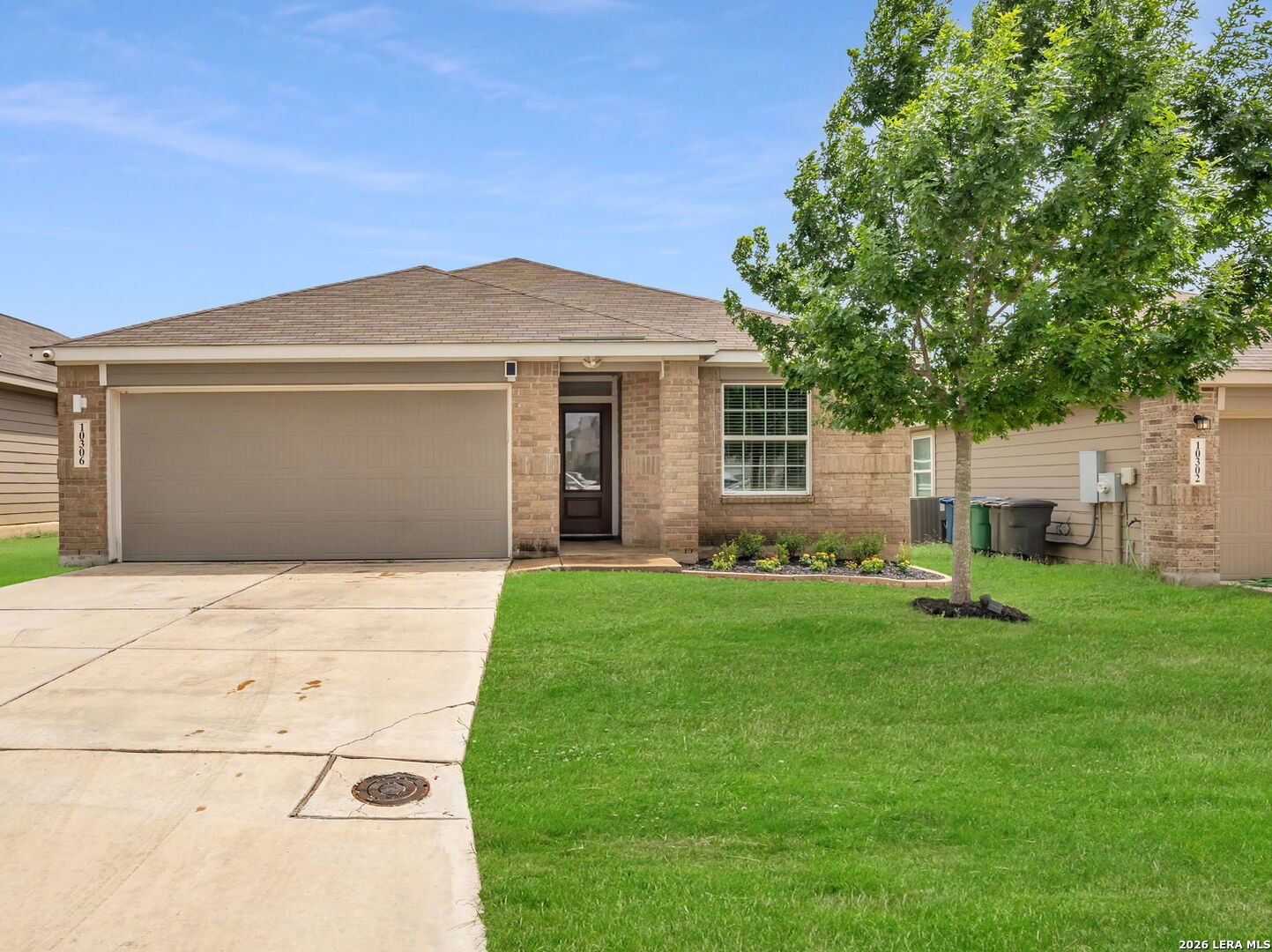 10306 Midsummer Meadow Converse, TX 78109 - Photo 2 of 26 a front view of a house with a garden and yard