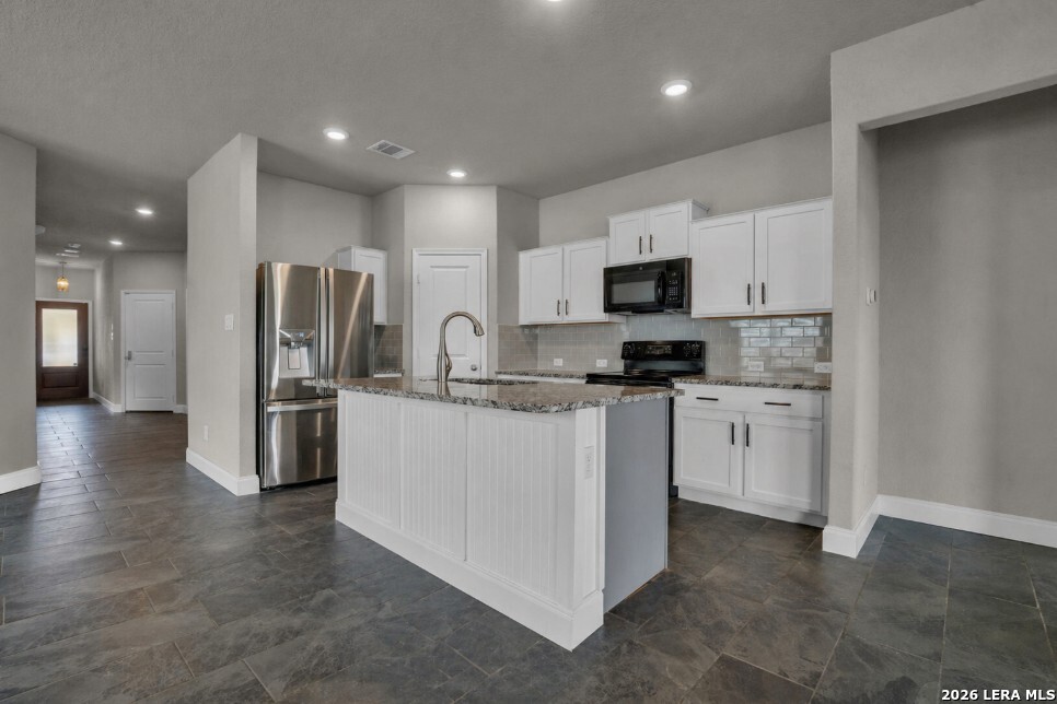 10306 Midsummer Meadow Converse, TX 78109 - Photo 6 of 26 a kitchen with stainless steel appliances a refrigerator stove microwave and sink