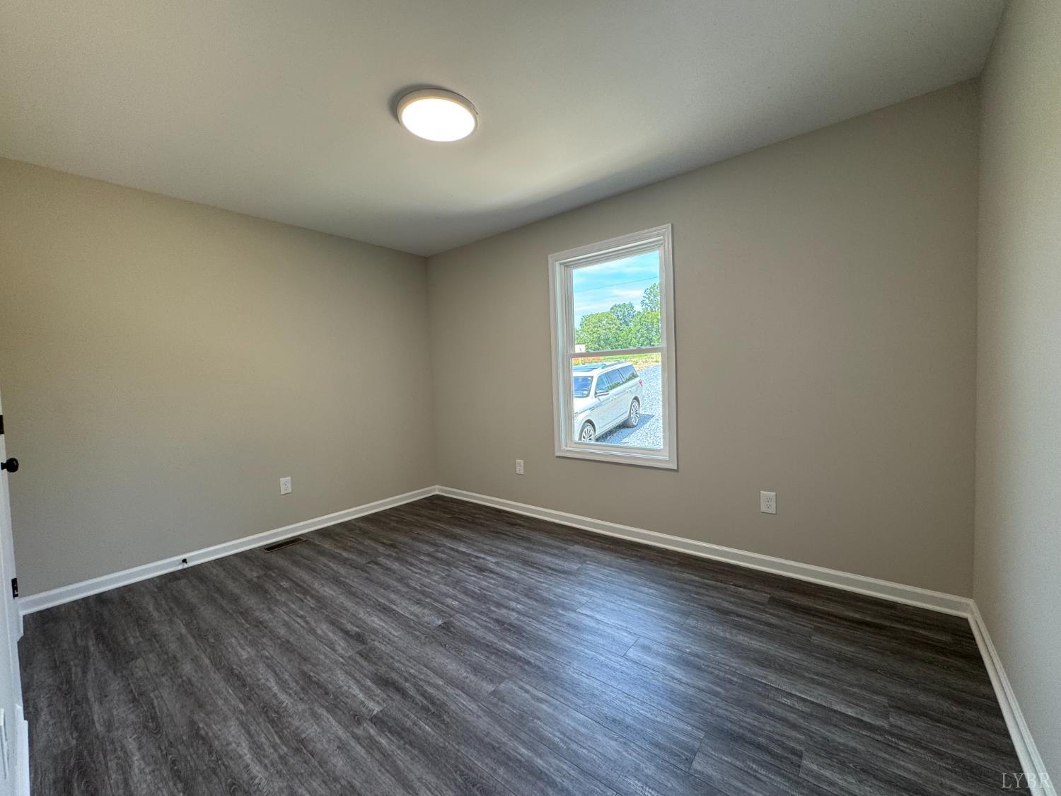 2350 Spg Grv Road Spout Spring, VA 24593 - Photo 15 of 24 an empty room with wooden floor and windows