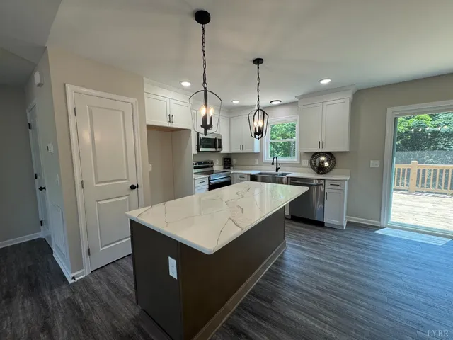 a large kitchen with stainless steel appliances kitchen island a large island in the center