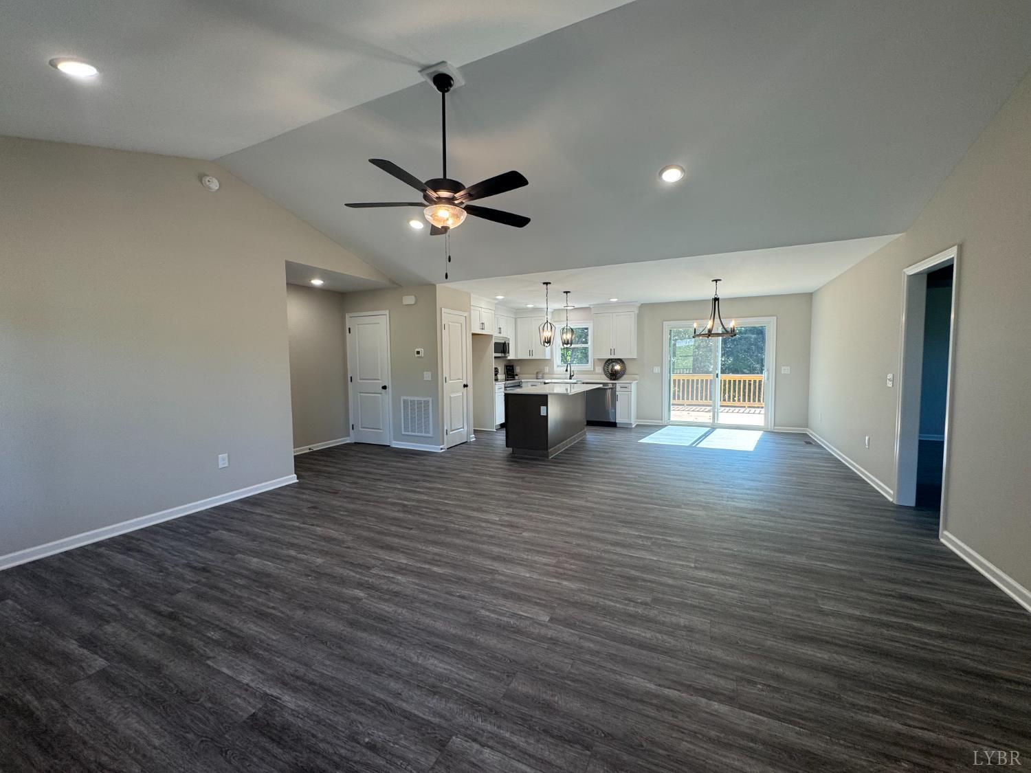 2350 Spg Grv Road Spout Spring, VA 24593 - Photo 5 of 24 a view of an empty room and kitchen view with wooden floor