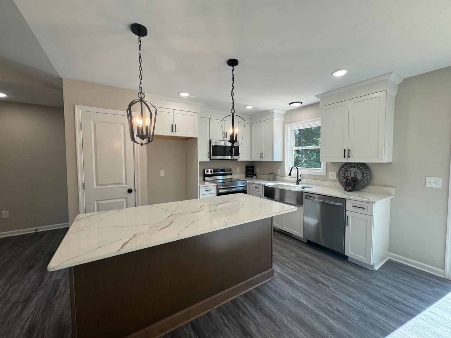 2350 Spg Grv Road Spout Spring, VA 24593 - Photo 6 of 24 a large kitchen with sink cabinets and stainless steel appliances
