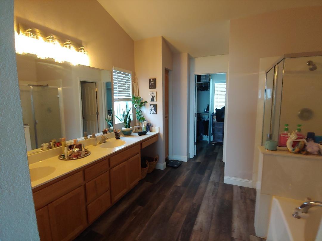 1190 Hazelnut Lane Madera, CA 93637 - Photo 12 of 18 a bathroom with a sink mirror and shower
