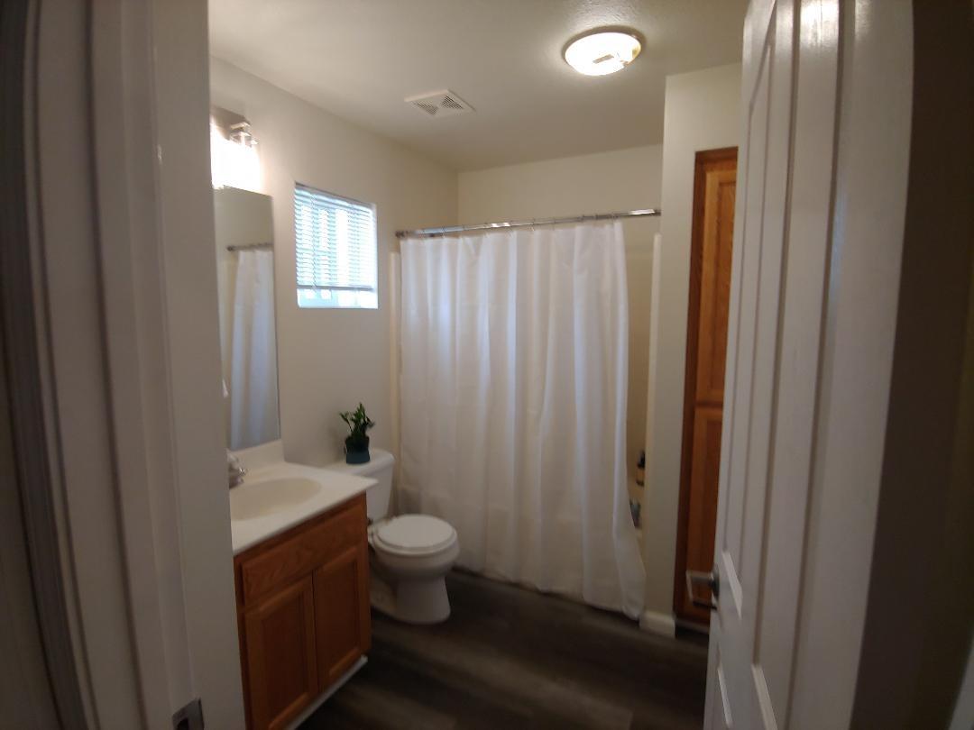1190 Hazelnut Lane Madera, CA 93637 - Photo 15 of 18 a bathroom with a sink and a mirror
