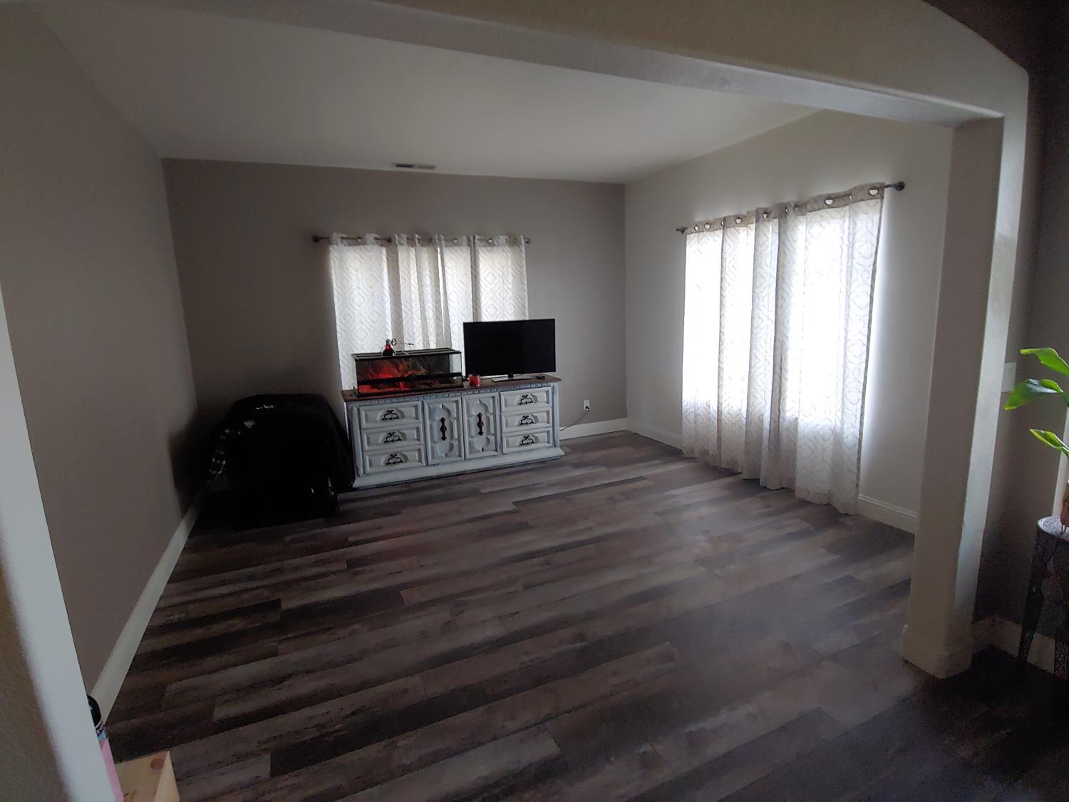 1190 Hazelnut Lane Madera, CA 93637 - Photo 2 of 18 a view of a livingroom with wooden floor and windows