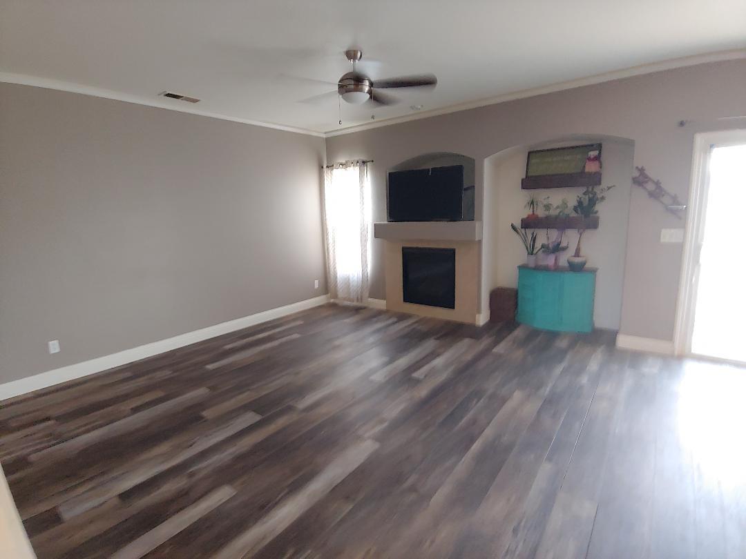 1190 Hazelnut Lane Madera, CA 93637 - Photo 4 of 18 wooden floor in an empty room with a fireplace